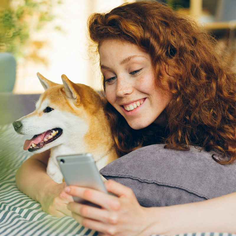 a smiling women holding a brown dogmobile-vet-service a smiling women holding a brown dog